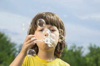 Baloncuklarla oynayan çocuk