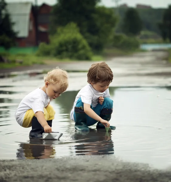 Three boy play in puddle — Stock Photo, Image