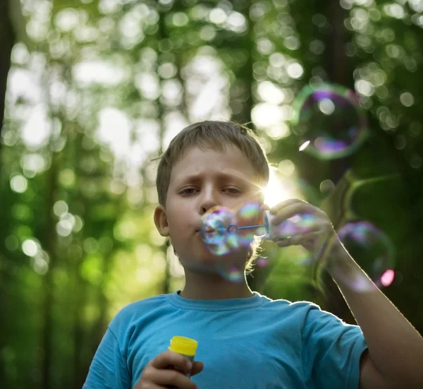 Boy play in bubbles — Stock Photo, Image