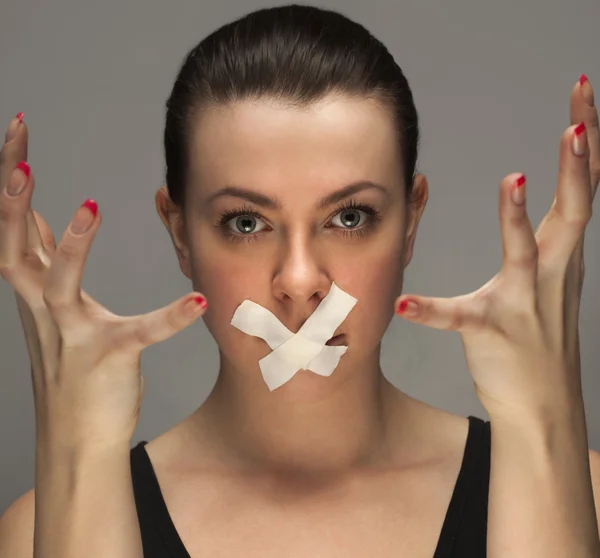 Beauty girl with tape on lips — Stock Photo, Image