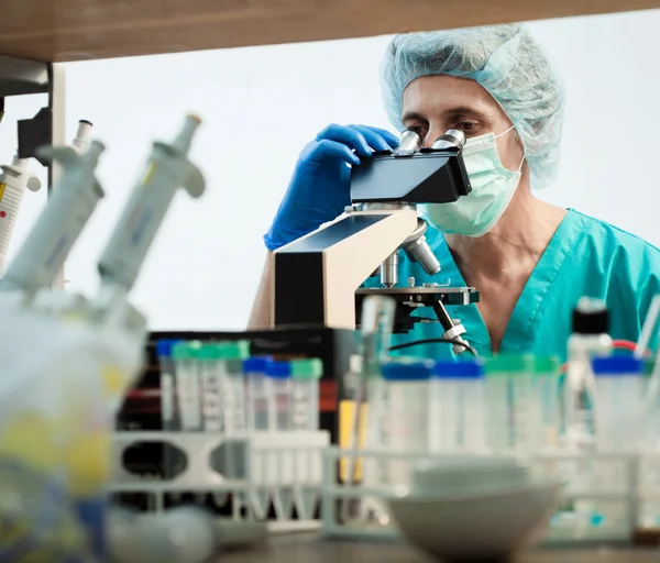 Cientista olhando para um microscópio — Fotografia de Stock