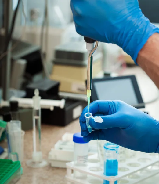 Scientist filling test tube — Stock Photo, Image