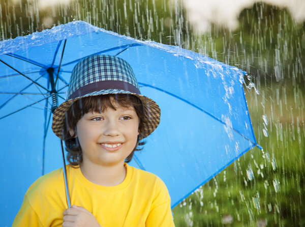 happy boy with umbrella outdoors