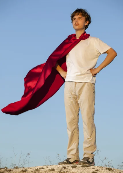 Boy playing superheroes on the sky background, teenage superhero — Stock Photo, Image