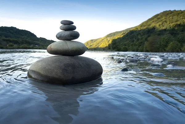 Rocks stack on the coast of Mountain River, concept of balance and harmony.