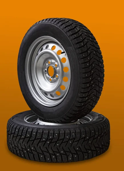 Car Wheel Winter Studded Tire Orange Background — Stock Photo, Image