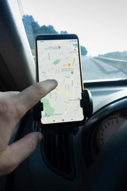 Arabada akıllı telefonlu bir el. Google Maps Navigator 'a bakıyorum. Google dünyadaki en büyük internet arama motorudur. Belgorod, Rusya - 13 Haziran 2020: