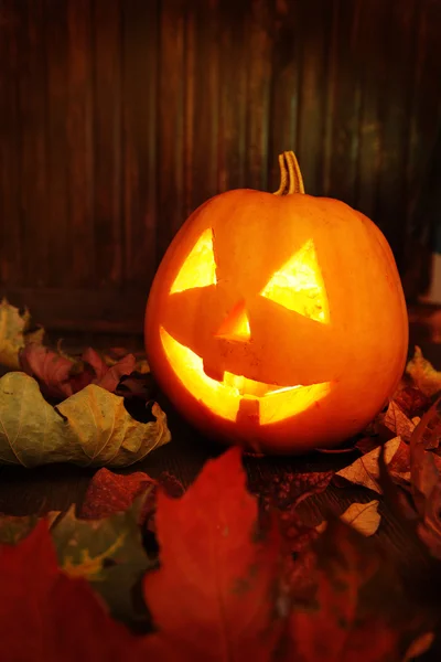 Jack o lanterns  Halloween pumpkin face on wooden background — Stock Photo, Image
