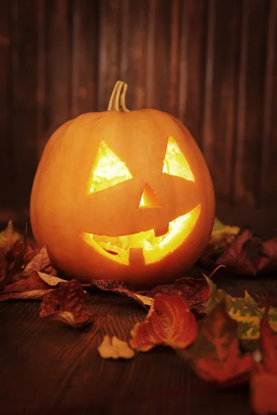 Jack o lanterns  Halloween pumpkin face on wooden background Stock Image