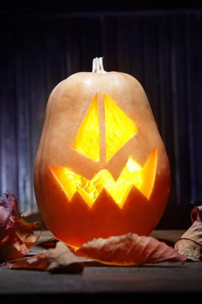 Jack o lanterns  Halloween pumpkin face on wooden background — Stock Photo, Image