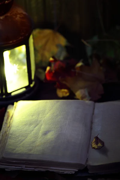Open blank book near a lantern — Stock Photo, Image