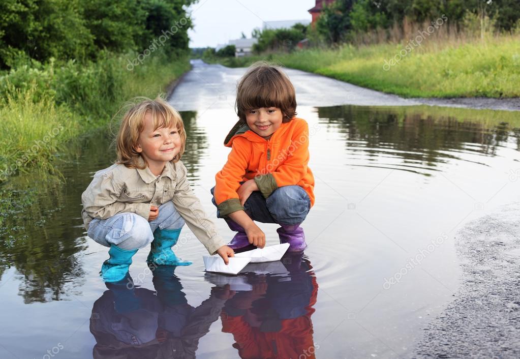 three boy play in puddle