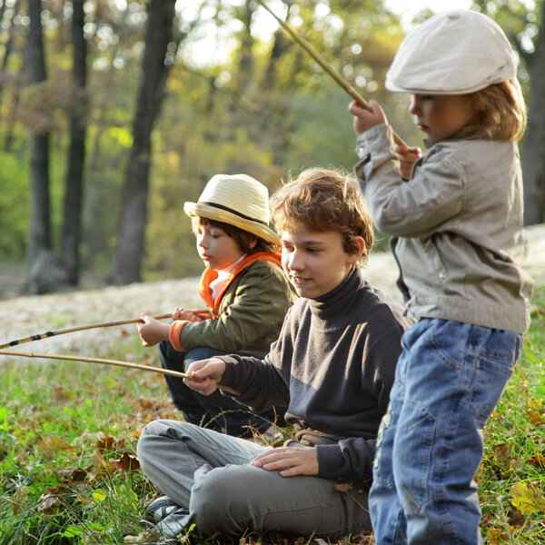 happy boys go fishing on the river