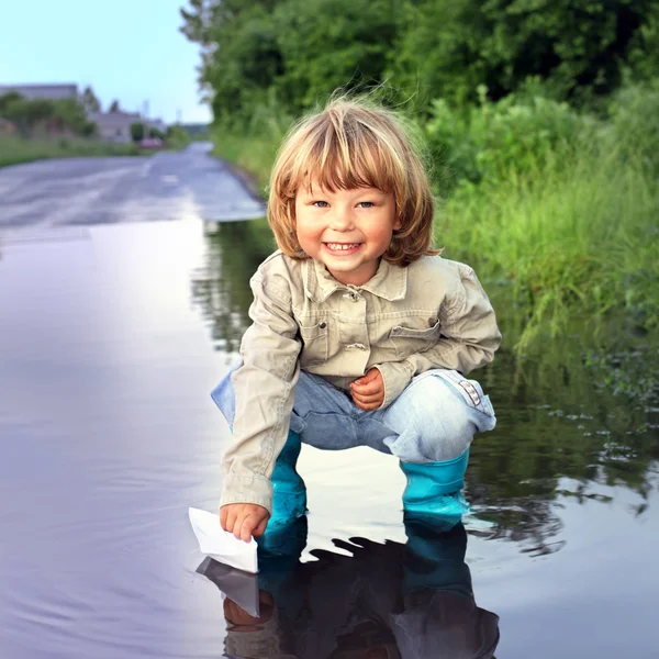 Three boy play in puddle — Stock Photo, Image