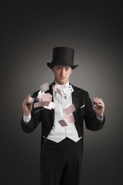 magician holding playing cards clipart