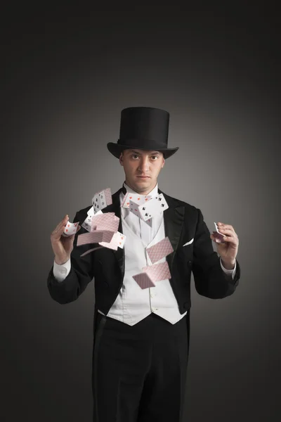 Magician holding playing cards — Stock Photo, Image