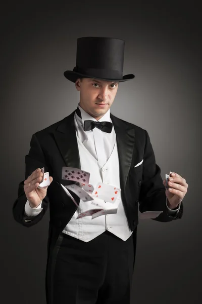 Magician holding playing cards — Stock Photo, Image