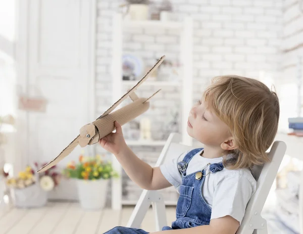 Jongen met vliegtuig in hand — Stockfoto