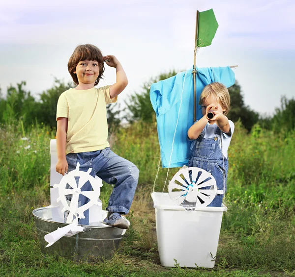 Happy boy in hand made ship outdoors play — Stock Photo, Image