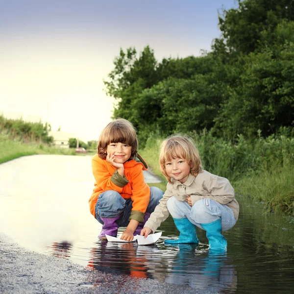 Three boy play in puddle — Stock Photo, Image