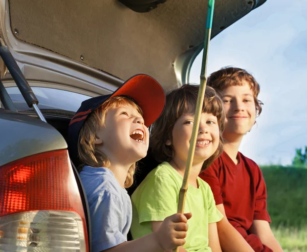 Bir arabanın doğası üzerine oturan üç çocuk — Stok fotoğraf
