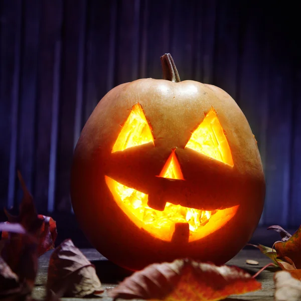 Jack o lanterns  Halloween pumpkin face on wooden background — Stock Photo, Image