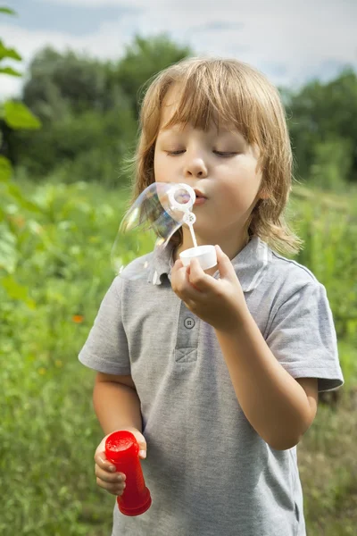 Boy play in bubbles — Stock Photo, Image