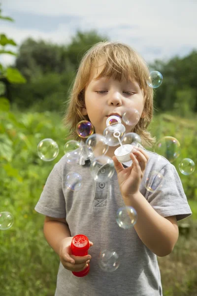 Boy play in bubbles — Stock Photo, Image