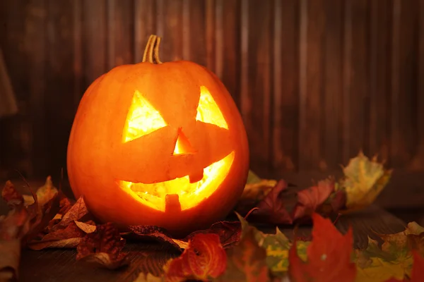 Cara de calabaza de Halloween Jack o linternas sobre fondo de madera — Foto de Stock