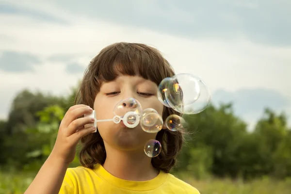 Boy play in bubbles — Stock Photo, Image