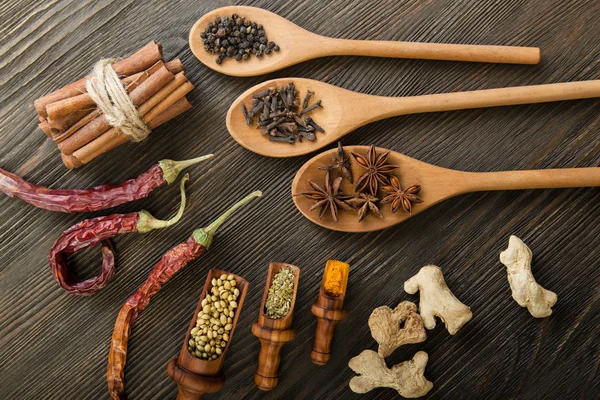 Kruiden en specerijen op houten achtergrond — Stockfoto