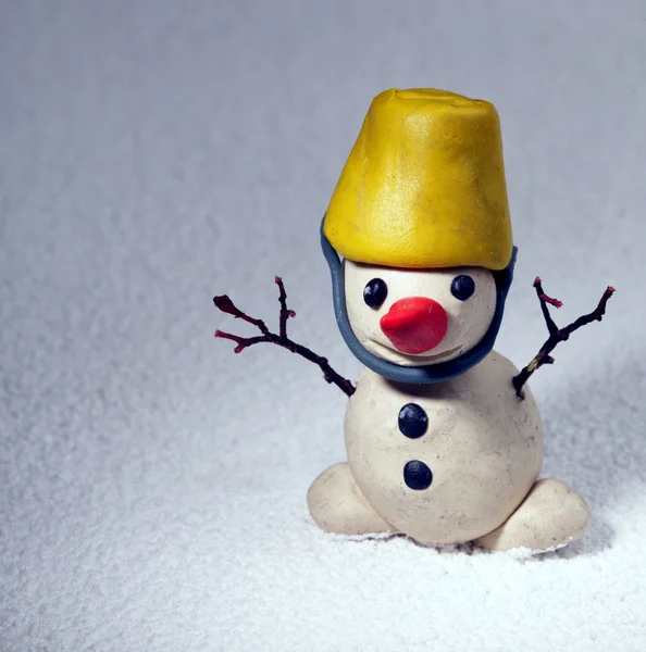 Little snowman made of plasticine standing on real snow — Stock Photo, Image