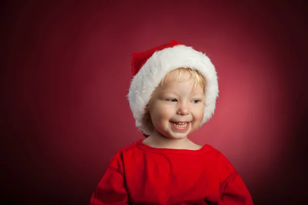 Happy baby in a Christmas cap — Stock Photo, Image