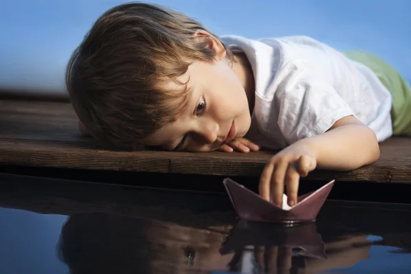 Boy play in paper ship — Stock Photo, Image