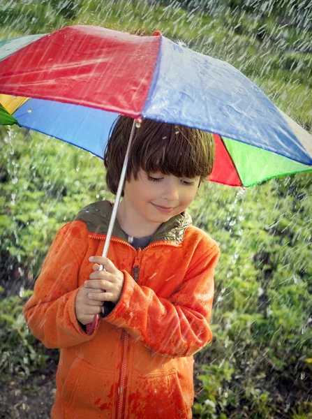 Boy with umbrella outdoors — Stock Photo, Image