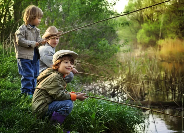 happy boys go fishing on the river