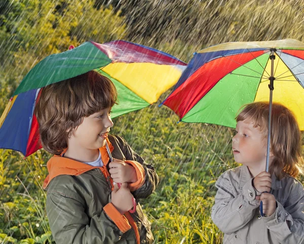 Happy brother with umbrella outdoors — Stock Photo, Image