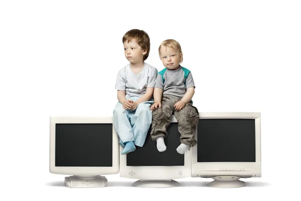 Boys sitting  on  monitor — Stock Photo, Image