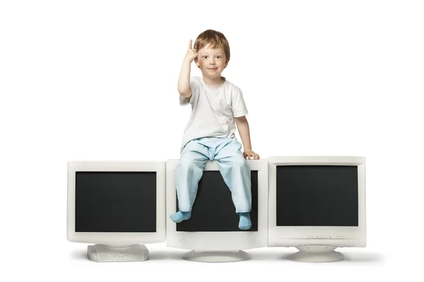 Boy sitting  on  monitor — Stock Photo, Image