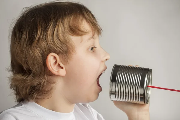 Boy speaking  in can telephone — Stock Photo, Image