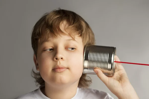 Boy listening to  can telephone — Stock Photo, Image