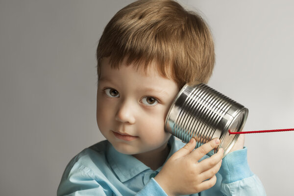 boy listening to  can telephone