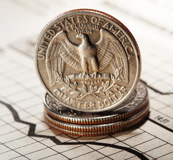 Quarter dollar on newspaper chart — Stock Photo, Image