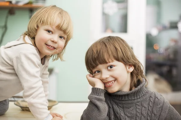 Twee vrolijke broer op de keukentafel — Stockfoto