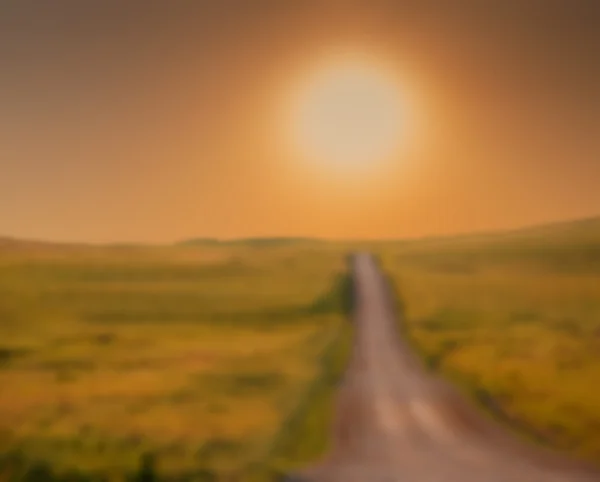 Astratto sfondo sfocato di una strada rurale che sale verso l'alba — Foto Stock