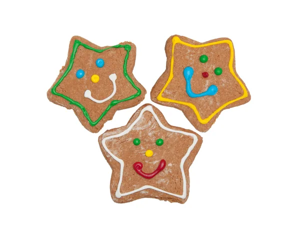 Three Christmas gingerbread star cookies with colorful happy icing on white — Stock Photo, Image