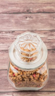 Kurutulmuş frambuaz adet cam ahşap arka plan üzerinde Mısır gevreği