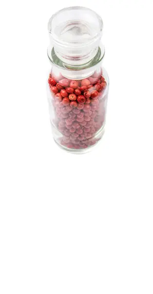 Varietà di grani di pepe rosa in fiala di vetro — Foto Stock