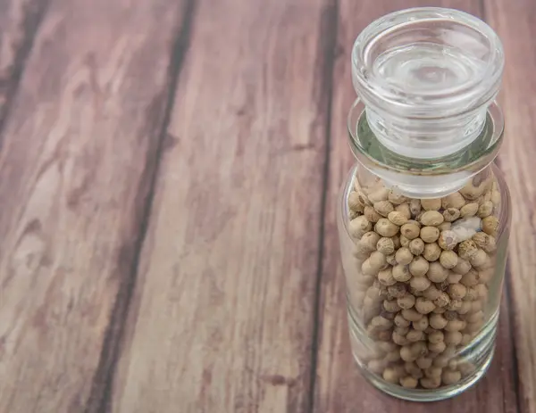 White peppercorns  In Glass Vial — Stock Photo, Image