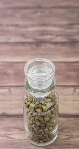 Green peppercorns  In Glass Vial — Stock Photo, Image